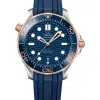 Produktbilde av Omega Seamaster Diver 300M Co-Axial Master Chronometer 42 MM. Steel ‑ Sedna™ Gold on Blue Rubber Strap. Ref. 210.22.42.20.03.002